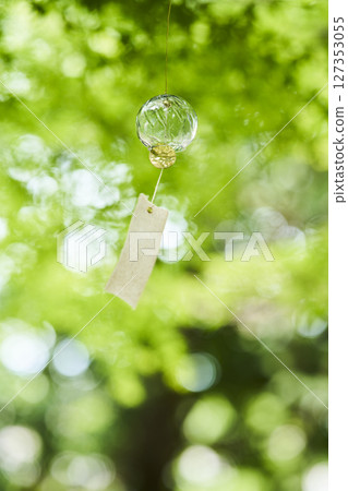 Wind chimes swaying in the wind under the summer sunlight 127353055