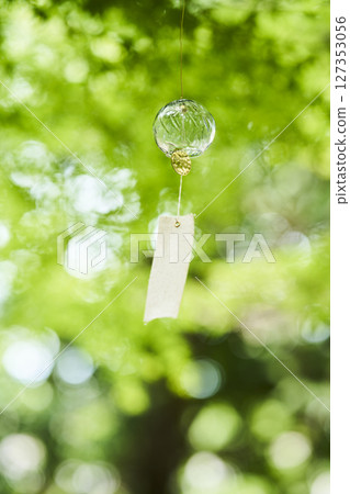 Wind chimes swaying in the wind under the summer sunlight 127353056