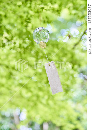 Wind chimes swaying in the wind under the summer sunlight Wind chimes swaying in the wind under the summer sunlight 127353087