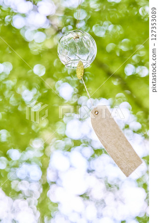 Wind chimes swaying in the wind under the summer sunlight Wind chimes swaying in the wind under the summer sunlight 127353089
