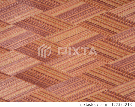 Interwoven mahogany strips reveal a rich tapestry of burnt sienna and copper, artfully aligned in a herringbone allure 127353218