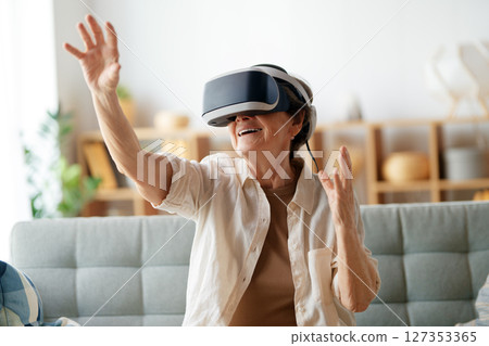 woman playing console games wearing vr goggles 127353365