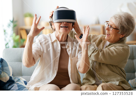 women playing console games wearing vr goggles 127353528