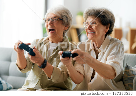 Two senior women playing console game 127353533