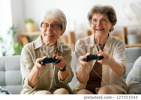 Two senior women playing console game 127353543