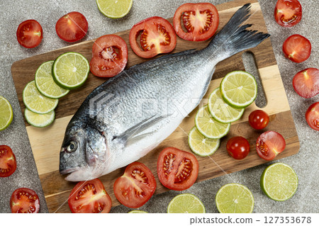 Raw Sea Bream and Lime on Kitchen Counter 127353678