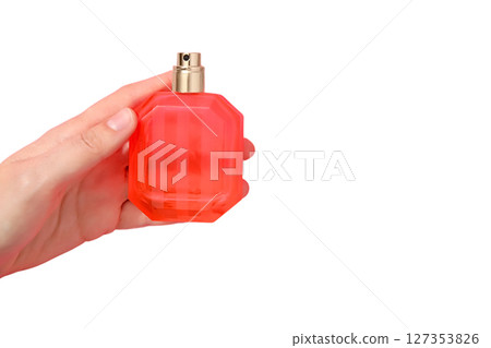 Hand holding red perfume bottle, isolated on white background 127353826