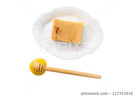 Honey and sweet treat displayed on a plate, isolated on white Honey and sweet treat displayed on a plate, isolated on white 127353838