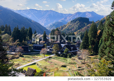 Traditional gassho zukuri houses in Ainokura village, Japan surrounded by autumn forests Traditional gassho zukuri houses in Ainokura village, Japan surrounded by autumn forests 127353920