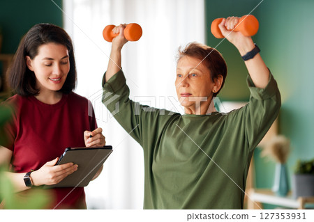 Senior woman doing dumbbell exercise 127353931