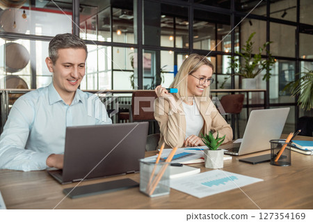 Layers working in the office and looking busy and contented Layers working in the office and looking busy and contented 127354169
