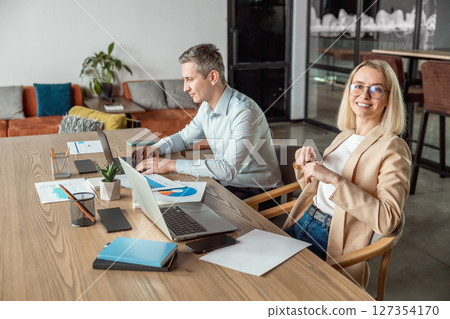 Layers working in the office and looking busy and contented Layers working in the office and looking busy and contented 127354170