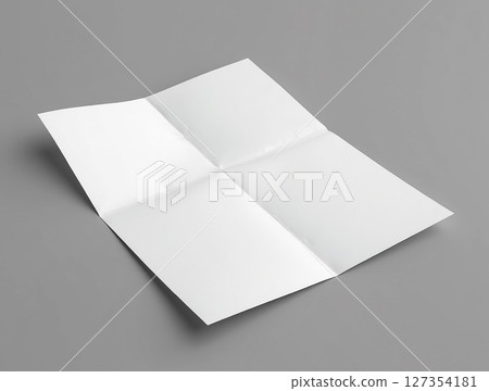 Blank sheet of folded paper resting on a smooth surface during daylight hours 127354181
