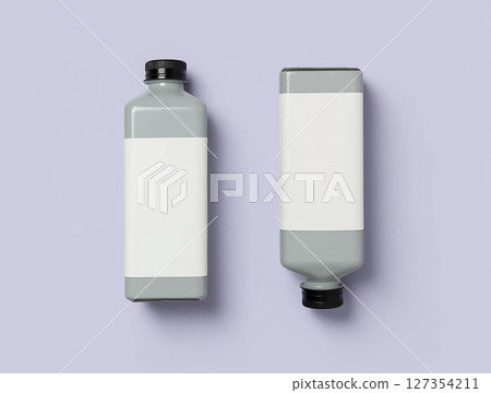 Gray bottles with blank labels positioned on a light purple background showcasing modern packaging design Gray bottles with blank labels positioned on a light purple background showcasing modern packaging design 127354211