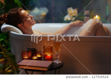 Peaceful Evening Bath with Book and Bubbles Peaceful Evening Bath with Book and Bubbles 127354528