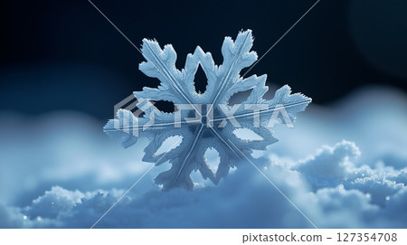 Unique snowflake resting on a soft layer of snow in a serene winter landscape at twilight 127354708