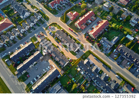 Aerial view of suburban neighborhood with modern houses and green gardens Aerial view of suburban neighborhood with modern houses and green gardens 127355392