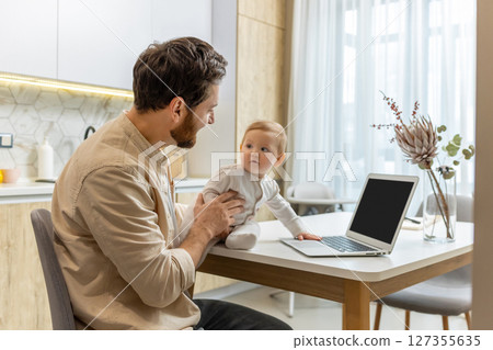 Young father with his little son at the laptop at home 127355635
