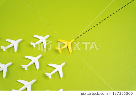 The planes fly behind the leader along the extended course. Aviation and passenger transportation. Leadership concept. Aviation industry coordination, and strategic direction in air transport. The planes fly behind the leader along the extended course. Aviation and passenger transportation. Leadership concept. Aviation industry coordination, and strategic direction in air transport. 127355800