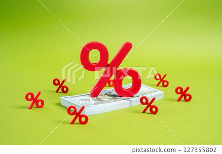 Interest on a stack of dollar bills. High taxes on profits and capital. Debt burden. Government debt. Concerns about public and private financial obligations. Interest on a stack of dollar bills. High taxes on profits and capital. Debt burden. Government debt. Concerns about public and private financial obligations. 127355802