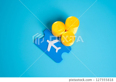 Stacks of coins and a plane ticket. Save on flights. Smart budgeting, flight discounts, and saving money on travel expenses through careful planning. Stacks of coins and a plane ticket. Save on flights. Smart budgeting, flight discounts, and saving money on travel expenses through careful planning. 127355818