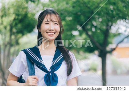 A high school girl in summer clothes commuting to school A high school girl in summer clothes commuting to school 127355942