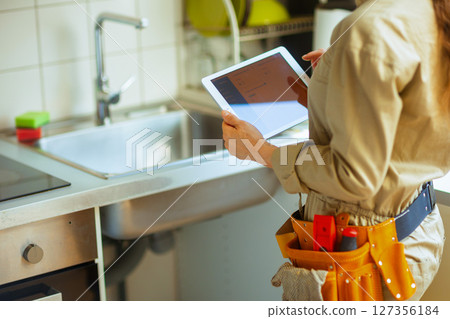 Handyworker with Tablet in Kitchen Handyworker with Tablet in Kitchen 127356184