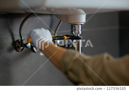 Plumber Repairing Sink Pipe Plumber Repairing Sink Pipe 127356185