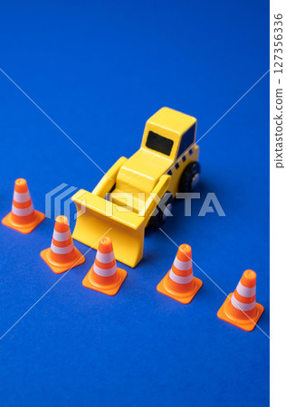A bulldozer pushes a border of traffic cones. Expanding boundaries and relaxing rules. Deregulation, policy relaxation, or broadening of legal boundaries in development or governance. A bulldozer pushes a border of traffic cones. Expanding boundaries and relaxing rules. Deregulation, policy relaxation, or broadening of legal boundaries in development or governance. 127356336