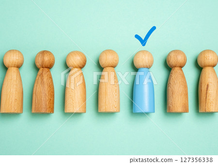 The person is indicated by a check mark above his head. Selecting a candidate or person. Winner. HR processes, recruitment success, promotion, or identifying a winner among many. The person is indicated by a check mark above his head. Selecting a candidate or person. Winner. HR processes, recruitment success, promotion, or identifying a winner among many. 127356338