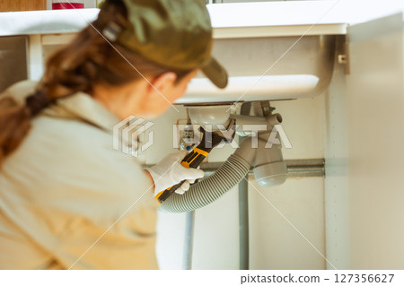 Plumber Adjusting Kitchen Sink Drain Plumber Adjusting Kitchen Sink Drain 127356627