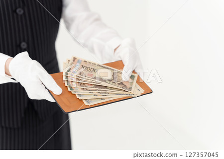 Woman holding money 127357045