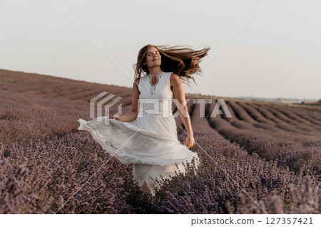 Woman Lavender Field Dress France: Summer photoshoot showcasing joyful carefree woman in flowing dress amidst Provence lavender fields. 127357421