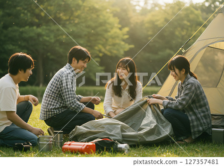 Young men and women camping and having fun outdoors 127357481