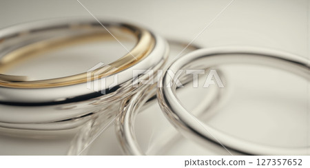 3D Metallic Rings Intertwined in a Minimalist Space A clean and modern 3D render featuring interlocking metallic rings in silver 127357652