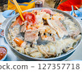 In hand with the Grill pork on wooden chopsticks 127357718
