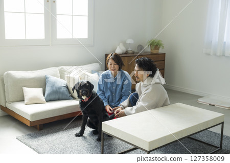 A couple relaxing with their dog 127358009