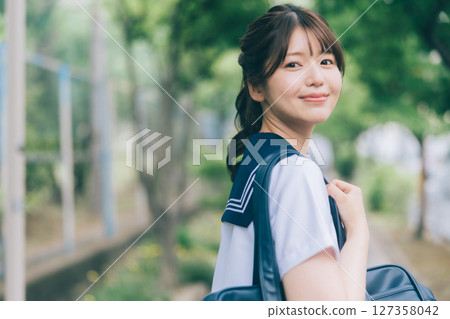 A high school girl in summer clothes commuting to school 127358042