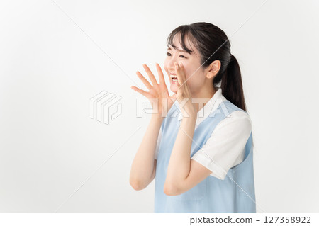 Young woman in apron cheering Young woman in apron cheering 127358922