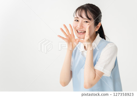 Young woman in apron cheering Young woman in apron cheering 127358923