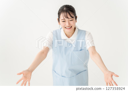Young woman in apron Young woman in apron 127358924
