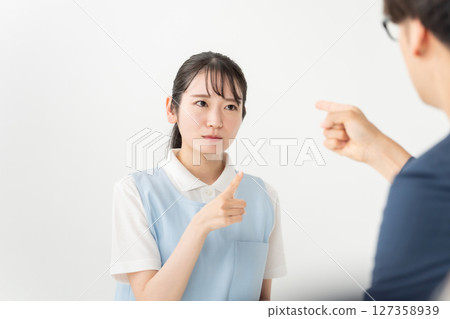Young woman in apron complaining 127358939