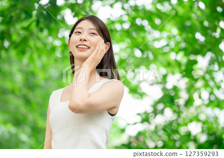 A woman relaxing in the fresh greenery A woman relaxing in the fresh greenery 127359293
