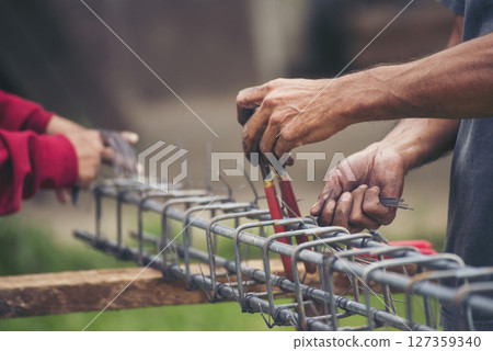 Construction Men hands bending cutting steel wire fences bar reinforcement of concrete work. Worker hands using pincer pliers iron wire. Outdoor Worker using wire bending pliers, construction work Construction Men hands bending cutting steel wire fences bar reinforcement of concrete work. Worker hands using pincer pliers iron wire. Outdoor Worker using wire bending pliers, construction work 127359340