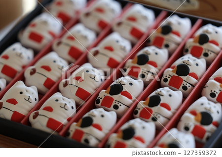 Lucky cat fortune slips for sale at Mitsuke Tenjin Shrine in Iwata, Shizuoka Prefecture 127359372