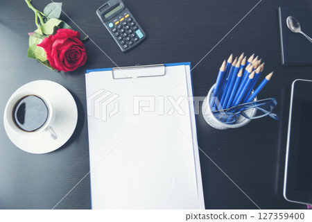Top view office desk smart tablet document paper, coffee cup roses on wood table with copy space. Tabletop notebook office empty blank white paper pen coffee cup to display workspace wood background Top view office desk smart tablet document paper, coffee cup roses on wood table with copy space. Tabletop notebook office empty blank white paper pen coffee cup to display workspace wood background 127359400