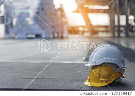 Construction hard hat safety tools equipment for workers in construction site for engineering protection head standard. Many hard hat helmet on row with copy space. Engineering Construction Concept Construction hard hat safety tools equipment for workers in construction site for engineering protection head standard. Many hard hat helmet on row with copy space. Engineering Construction Concept 127359417