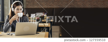 Banner Women helpdesk call center use headphones talk to customer. Asian woman customer service relationship agent. Businesswoman use laptop computer video call online meeting with copy space 127359510