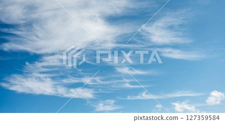 Soft white cirrus clouds against the blue sky Soft white cirrus clouds against the blue sky 127359584