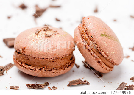 Macaroons with chocolate cream on a light background. Macaroons with chocolate cream on a light background. 127359956